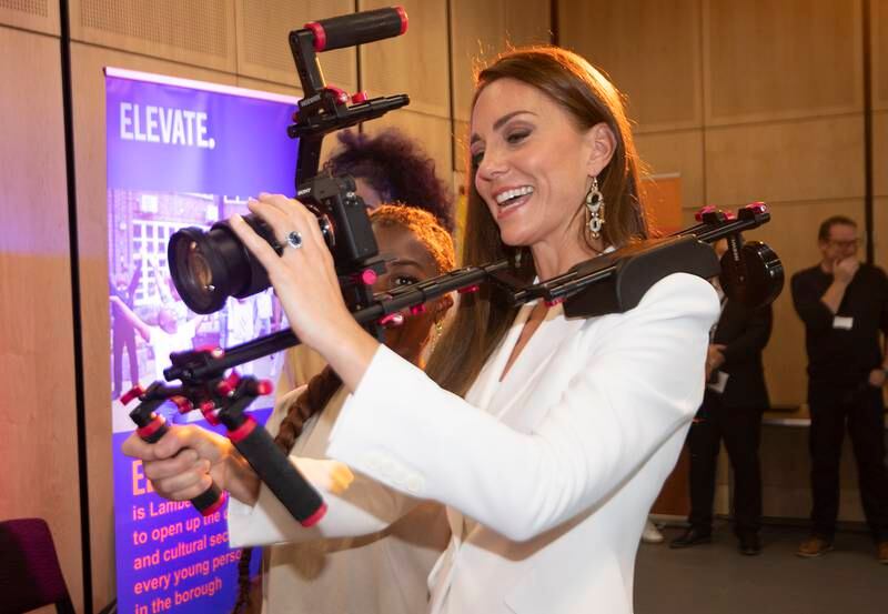 Kate holds a video camera while speaking to people from the ELEVATE initiative at Brixton House. Getty Images