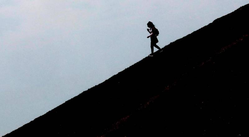 A woman walks down a hill at Northala fields in London. AP Photo