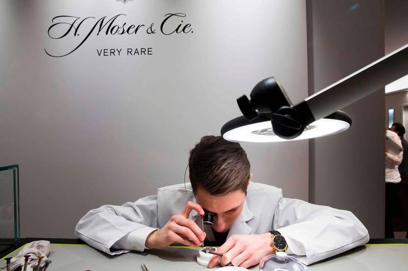 An employee of Swiss watchmaker H Moser & Cie assembles a wristwatch at the Salon International de la Haute Horlogerie professional fair in fine watchmaking in Geneva. AFP