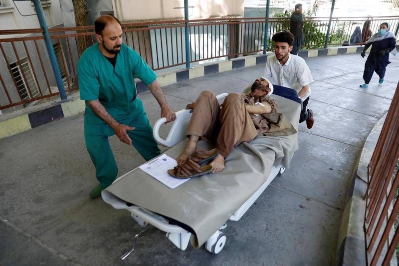 Men transport an injured man to a hospital after a blast in Kabul. REUTERS