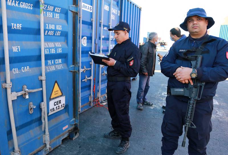 A Tunisian customs officer inspects containers filled with illegally imported Italian waste before they are returned to Salerno.