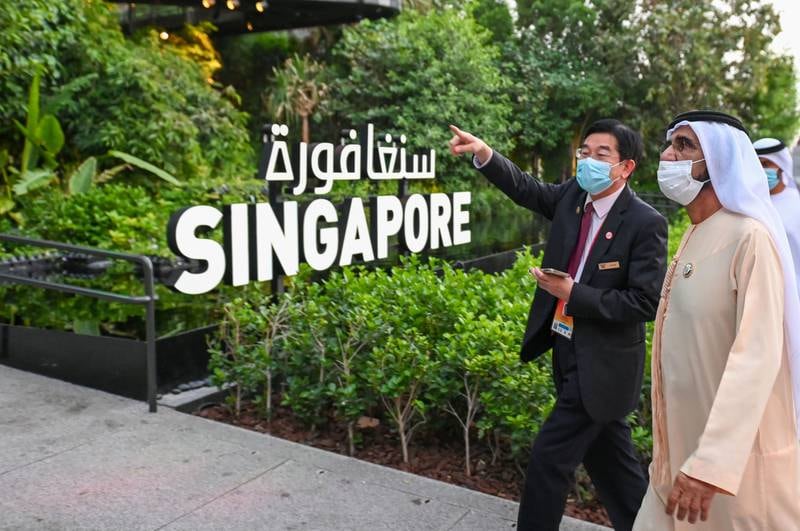 Sheikh Mohammed is given a tour of the Singapore pavilion. Its design is intended to show that nature can thrive in the desert – if helped sustainably.