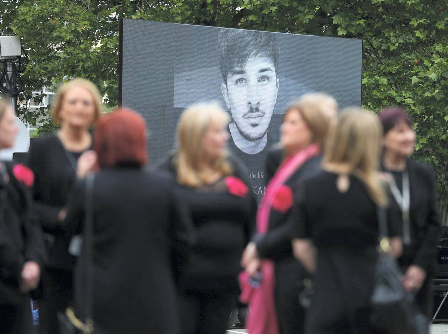 STOCKPORT, ENGLAND - JUNE 30: A screen displaying an image of Martyn Hett outside Stockport Town Hall as mourners arrive for his funeral on June 30, 2017 in Stockport, England.  29 year old Martyn Hett was one of 22 people who died in the suicide bombing at Manchester Arena after attending an Ariana Grande concert. Scottish singer Michelle McManus will perform at the service which will be screened outside for anyone who cannot fit inside the venue. (Photo by Dave Thompson/Getty Images)