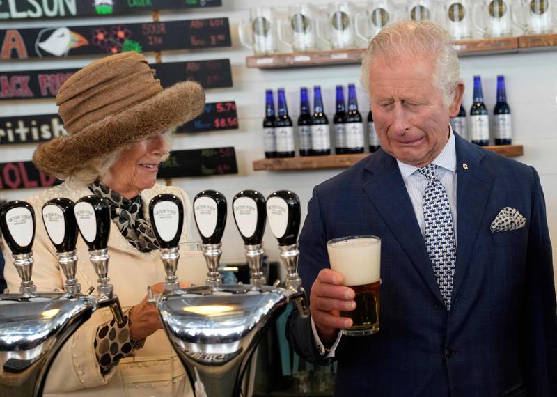 The Duchess of Cornwall looks on as Prince Charles reacts to a bad pour of beer he made at the Quidi Vidi Brewery in Newfoundland and Labrador, as they begin a three-day Canadian tour.  AFP