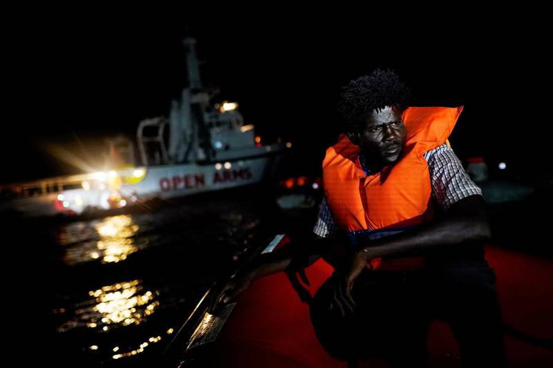 A migrant sits on board the NGO Proactiva Open Arms rescue boat in the central Mediterranean Sea, August 2, 2018. REUTERS/Juan Medina      TPX IMAGES OF THE DAY