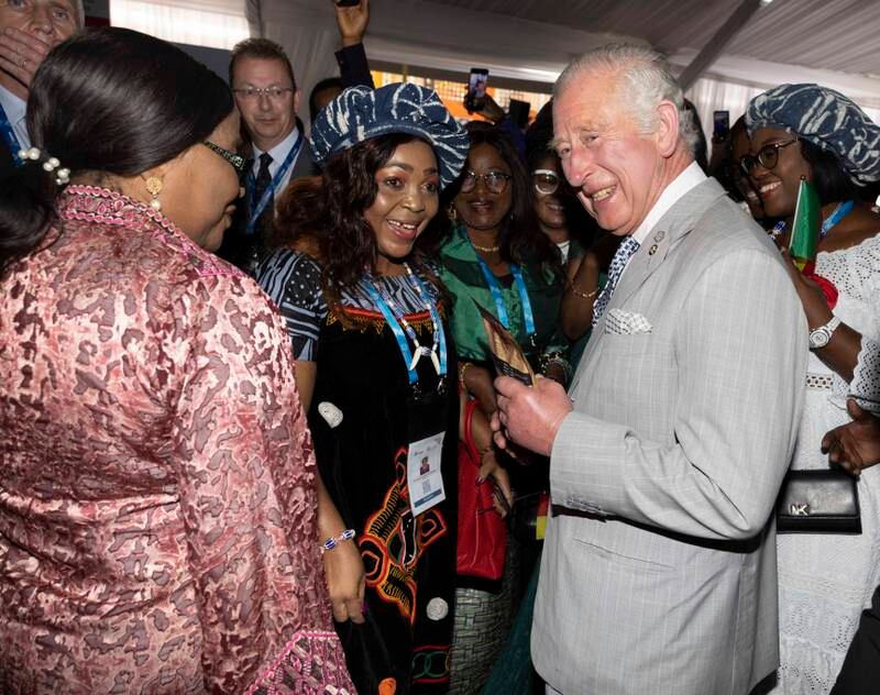 Prince Charles speaks with guests while attending the Business Forum Exhibition at the Kigali Cultural Village. Getty Images