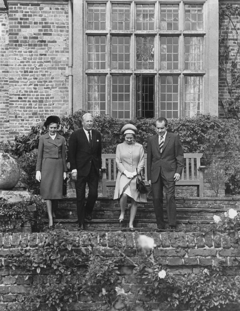 Former US president Richard Nixon, Queen Elizabeth, and former British prime minister Edward Heath walking in the rose garden at Chequers, the prime minister's official residence in England, in October 1970. Getty Images