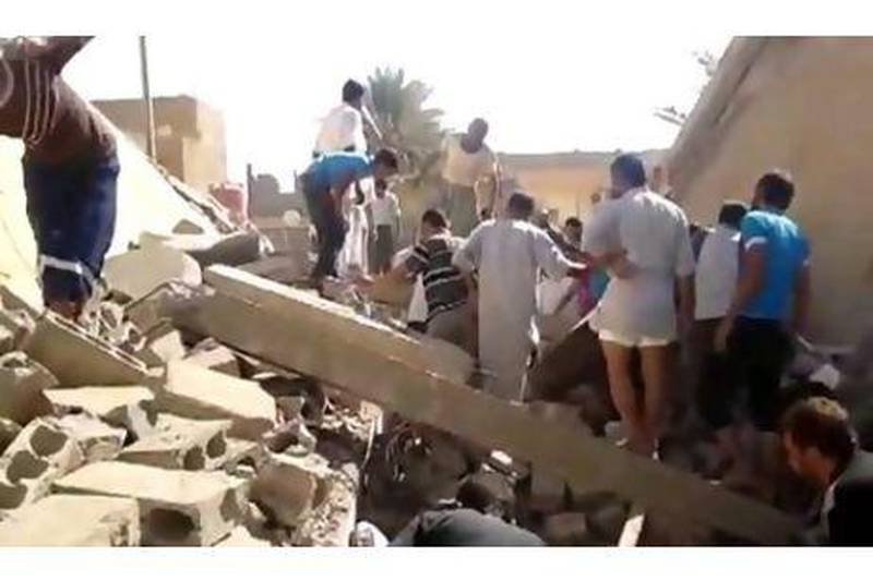 People search for survivors in the rubble of a buildinin Boukamal province of Deir Ezzour.