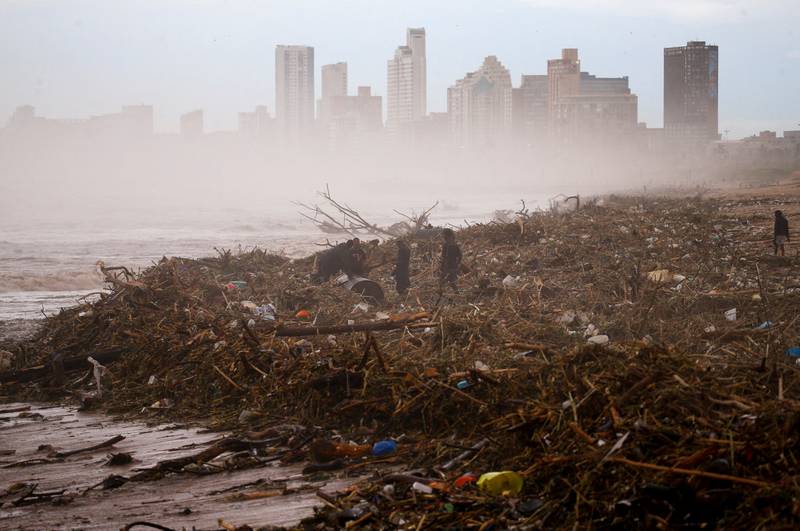 People search for items they can salvage on the beach after heavy rains caused flooding in Durban, South Africa. Reuters