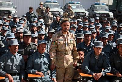 In this photo taken on February 19, 2017, Afghan General Abdul Raziq (C), police chief of Kandahar, poses for a picture during a graduation ceremony at a police training centre in Kandahar province. An Afghan security chief and a journalist were killed and three Americans wounded on October 18 when a gunman opened fire on a high-level security meeting attended by top US commander General Scott Miller, officials said.  / AFP / JAWED TANVEER
