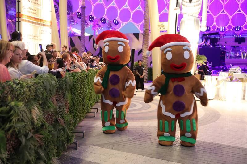 Giant gingerbread men interact with visitors during the event. Pawan Singh / The National
