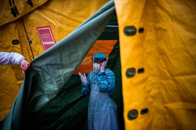 A medical staffer at Sophiahemmet hospital talks on a phone inside a tent for testing and receiving potential coronavirus COVID-19 patients in Stockholm.  AFP