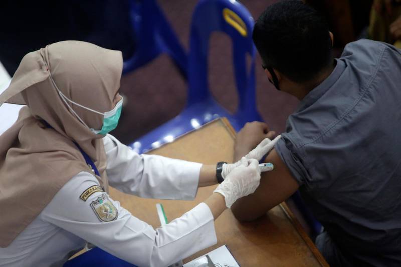An Aceh government staff member receives the Sinovac Covid-19 vaccine during a mass vaccination drive for Aceh civil servants and government officials in Banda Aceh, Indonesia. EPA