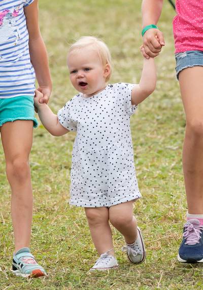 Toddler Lena Tindall walks with her cousins Savannah Phillips and Isla Phillips during the Festival of British Eventing at Gatcombe Park on August 04, 2019.