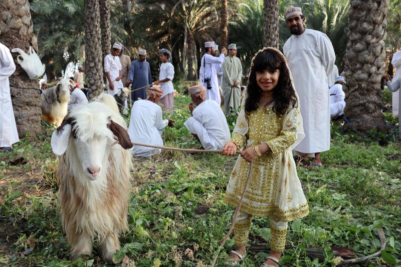 Omanis gather as goats are sold ahead of the Eid Al Fitr holiday, in the Surur area of Samail province, 80 kilometres south-west of the capital Muscat. AFP