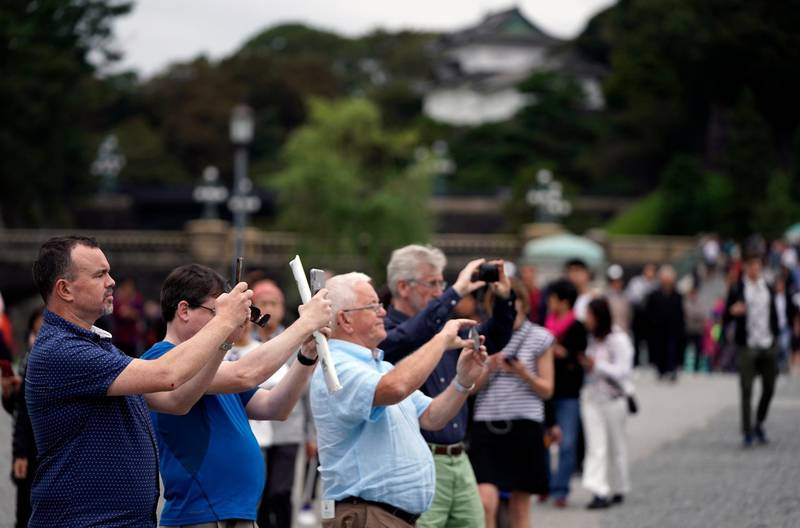 Visitors take pictures at the Imperial Palace outer garden in Tokyo, Japan.  EPA