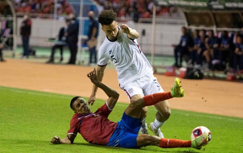 Costa Rica's Carlos Martinez, left, vies for the ball with USA's Antonee Robinson during their World Cup 2022 qualifier at the National Stadium in San Jose on Wednesday, March 30, 2022. AFP