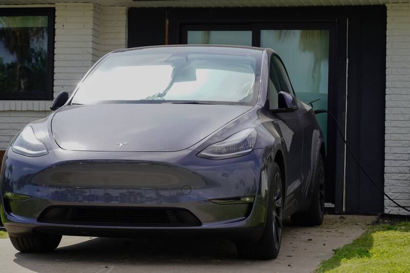 A Tesla charges in the driveway of a house in Boca Chica.