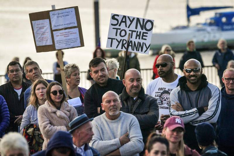 People attend an anti-lockdown protest outside the Senedd Cymru in Cardiff Bay, Wales. AP Photo