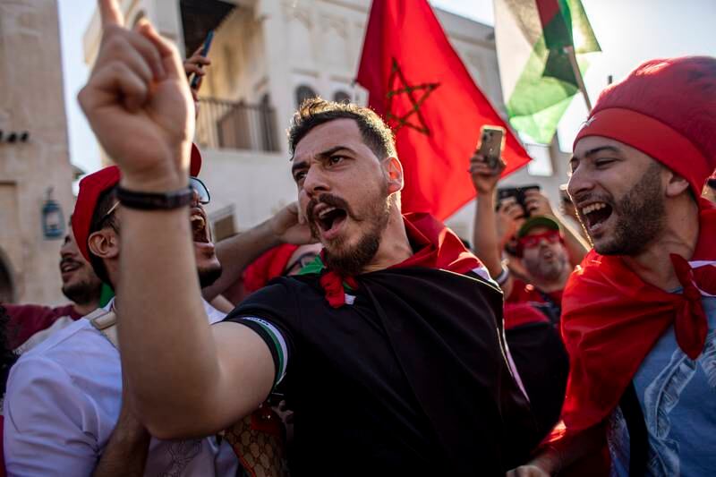 Fans of Morocco cheer at the Souq Waqif market. EPA
