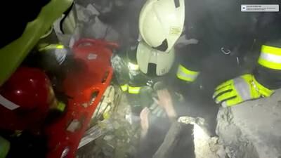 Ukrainian firefighters rescue a person buried beneath rubble after an explosion at a shopping centre in Kyiv. Reuters