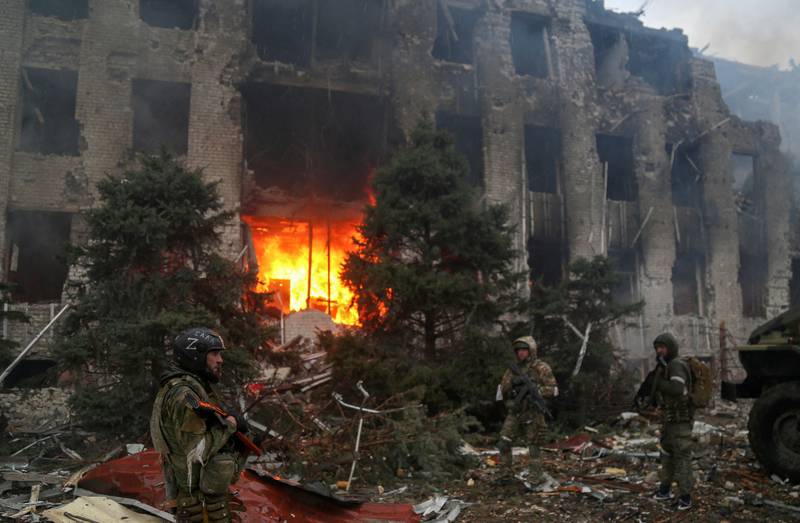 Pro-Russian troops, including fighters of the Chechen special forces unit, survey the destroyed administration building of Azovstal Iron and Steel Works in Mariupol, Ukraine. Reuters