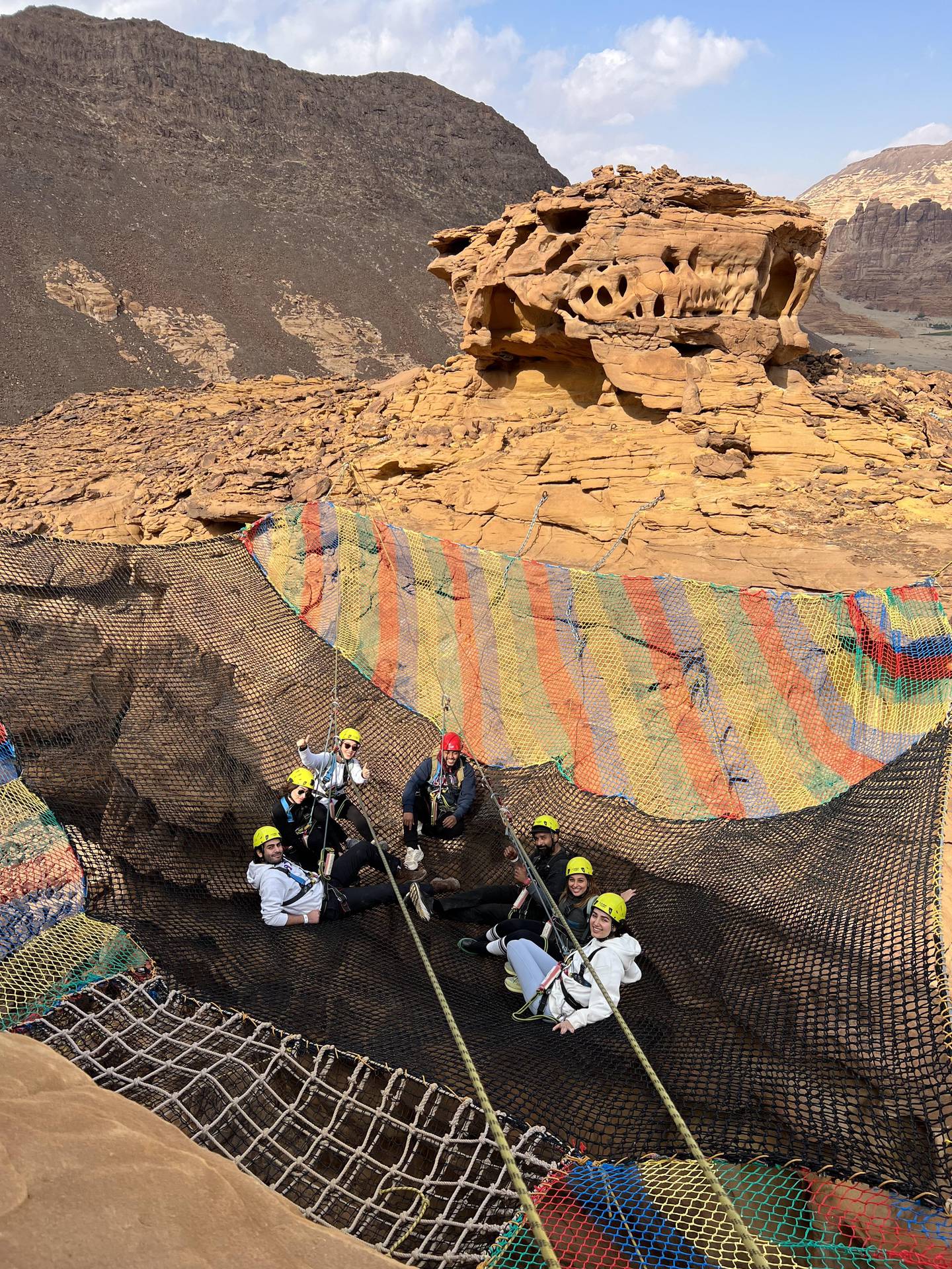Tourists rock climbing in AlUla