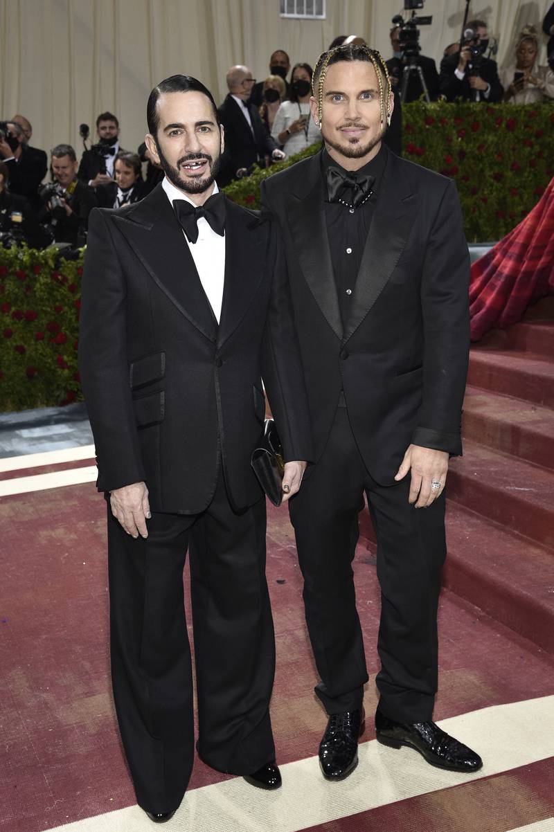 Marc Jacobs, wearing a tuxedo and over-sized black bow tie, and Char Defrancesco. AP Photo