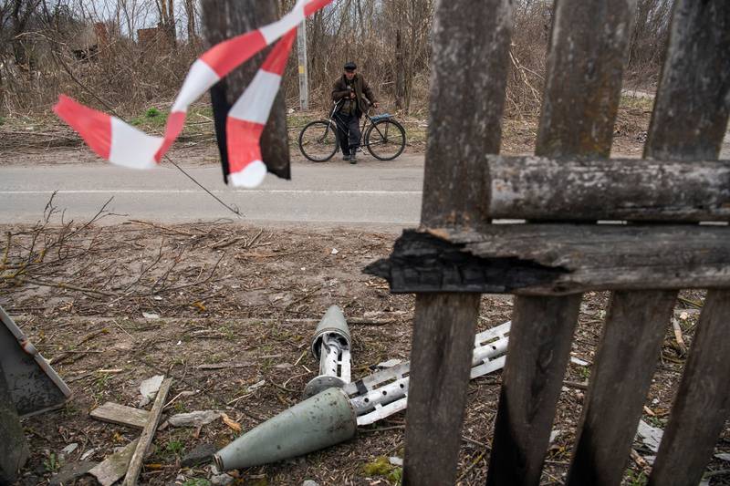A local resident Serhii stands next to a used multiple rocket launch shell, as Russia?s invasion on Ukraine continues, in the village of Kukhari, in Kyiv region, Ukraine. Reuters