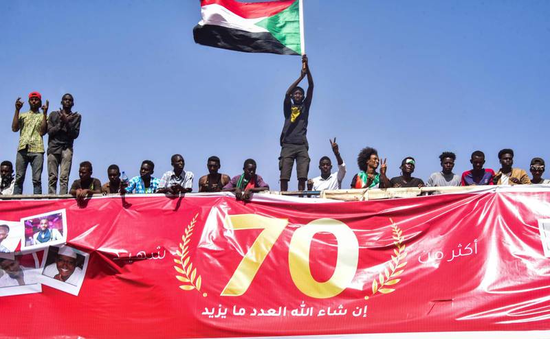 A Sudanese demonstrator waves a national flag. AFP
