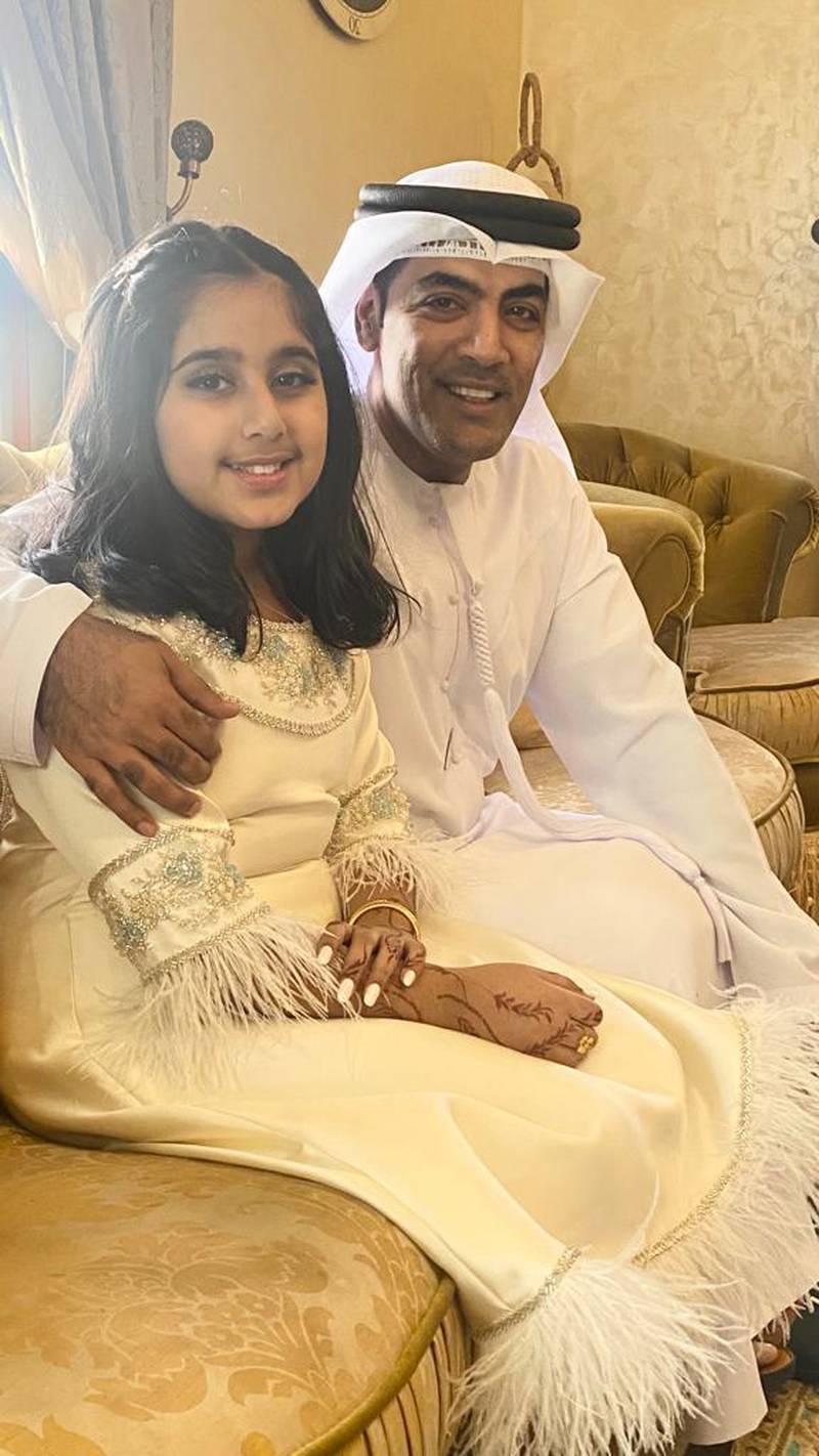 Nassir Al Kashwani, 45, a Sharjah Department of Finance employee, with his daughter Hajar, 8, at their home. Photo: Nassir Al Kashwani
