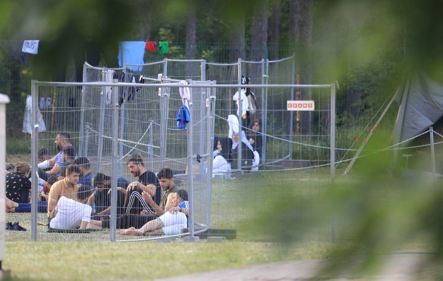 Migrants are seen through fences in a camp near the border town of Kapciamiestis, Lithuania. AFP 