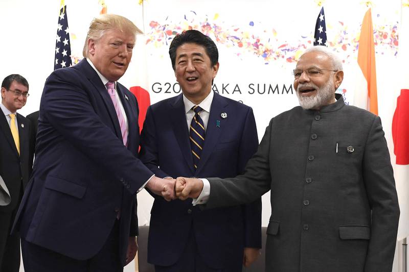 U.S. President Donald Trump, left, Shinzo Abe, Japan's prime minister, center, and Narendra Modi, India's prime minister, place their fists together during a trilateral meeting at the Group of 20 (G-20) summit in Osaka, Japan, on Friday, June 28, 2019. The world's most powerful leaders are gathering in Japan for meetings that may set the direction for the global economy and make the difference between war and peace in geopolitical hotspots. Photographer: Carl Court/Pool via Bloomberg