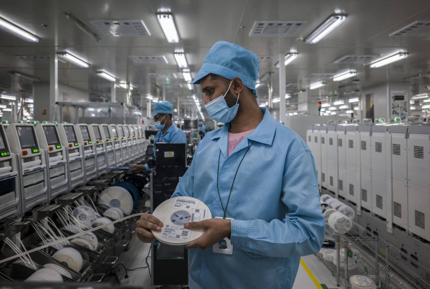 Workers at Samsung's surface mount technology workshop inside the Realme factory in Greater Noida, India. Bloomberg