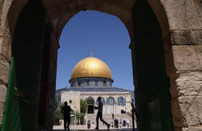 Palestinian Muslim worshippers walk in Jerusalem's al-Aqsa mosque compound, the third holiest site of Islam, on May 14, 2021.  / AFP / ahmad gharabli
