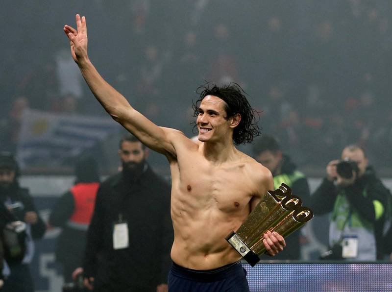 Paris St Germain's Edinson Cavani waves to fans in February after being presented with a trophy for becoming the first PSG player to score 200 goals for the club. Reuters