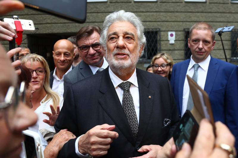 FILE - In this Aug. 25, 2019, file photo, Placido Domingo talks to fans at the "Festspielhaus" opera house after he performed "Luisa Miller" by Giuseppe Verdi in Salzburg, Austria. Domingo resigned Wednesday, Oct. 2, as general director of the Los Angeles Opera and withdrew from future performances at the company following multiple allegations of sexual harassment reported by The Associated Press. (AP Photo/Matthias Schrader, File)