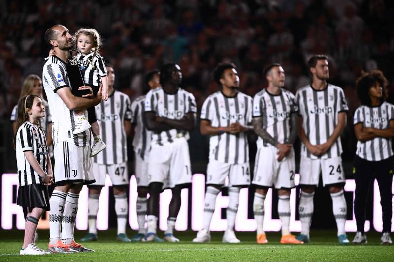 Juventus Italian defender Giorgio Chiellini holds his daughter as the stadium pays tribute to him for his last home match. AFP