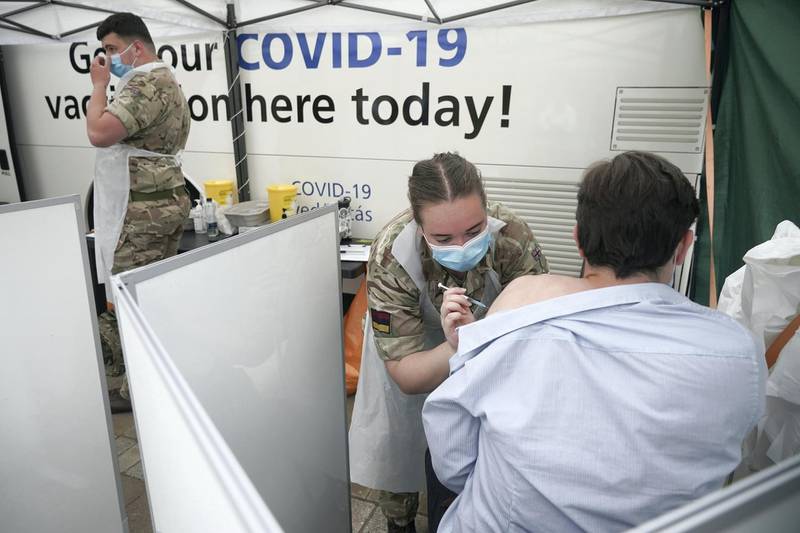 BOLTON, ENGLAND - JUNE 09: Combat medics from Queen Alexandra's Royal Army Nursing Corps vaccinate members of the public at a rapid vaccination centre, set up outside Bolton Town Hall on June 09, 2021 in Bolton, England. To help curb the spread of the Delta variant of Coronavirus in the North West of England Health Minister, Matt Hancock, has promised support from the military and increased testing in schools. Local leaders have asked for an increase in the vaccination program. The spread of the Delta variant, first discovered in India, has provoked debate on whether the so-called "Freedom Day" date of June 21 will be able to go ahead and see the full re-opening of British services and businesses.  (Photo by Christopher Furlong/Getty Images)