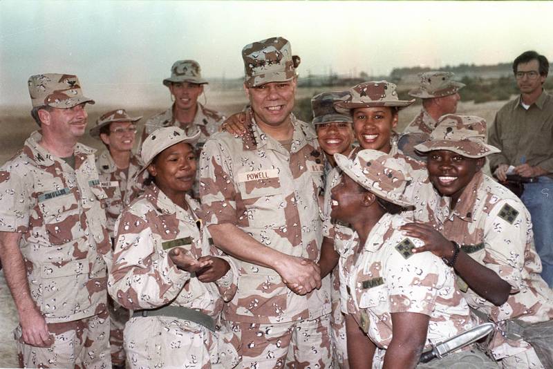 Gen Powell, then the chairman of the joint chiefs of staff, with members of the 132nd MP Company in Saudi Arabia, in December 1990. Reuters