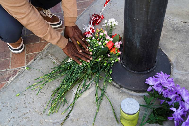 A person lays down flowers as members of the community hold a prayer vigil near the scene of the shooting. Reuters