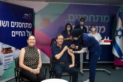Israeli President Isaac Herzog and his wife Michal receive their third coronavirus vaccine injections at Sheba Medical Centre in Ramat Gan, Israel.