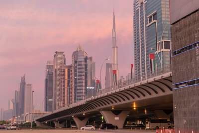 UAE flags fly along Sheikh Zayed Road between Business Bay and Al Safa in Dubai. Antonie Robertson / The National

