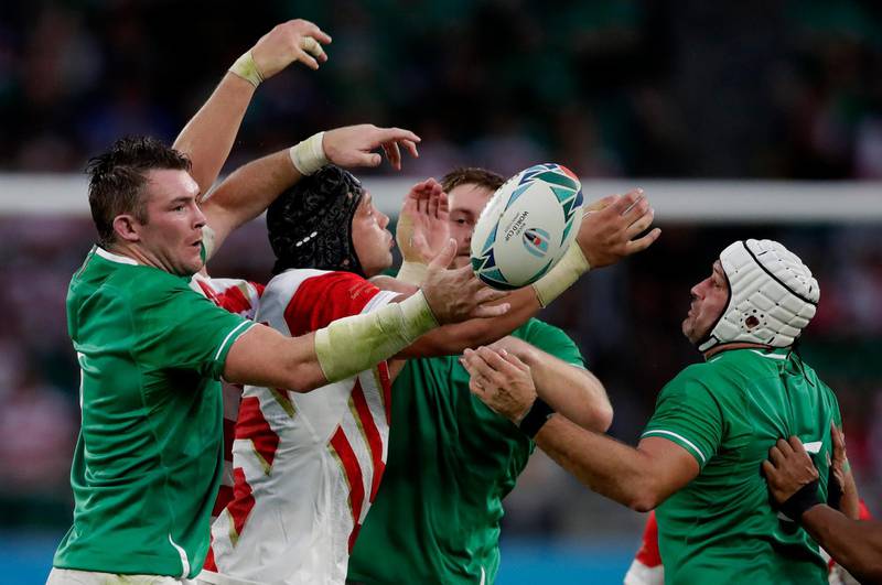 Japan's James Moore battles for the ball with Irish defenders during the Rugby World Cup Pool A game at Shizuoka Stadium Ecopa between Japan and Ireland in Shizuoka, Japan. AP Photo
