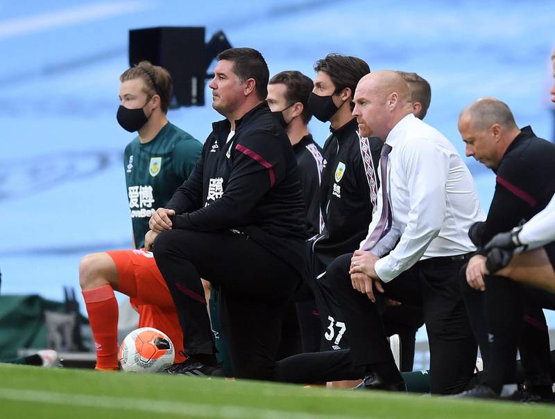 Burnley manager Sean Dyche takes a knee in support of the Black Lives Matter movement. AFP