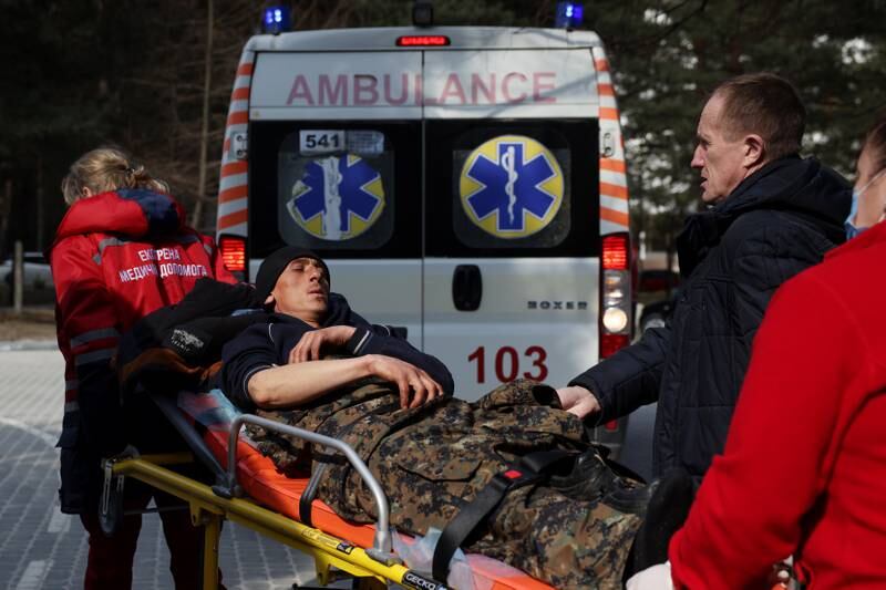 A man wounded in an air strike is helped by medical staff in Novoiavorivsk, western Ukraine. Getty