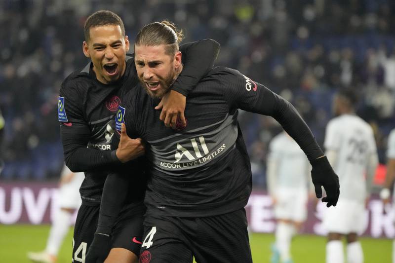 PSG's Sergio Ramos, right, celebrates with PSG's Thilo Kehrer after scoring his side's second goal during the French League One soccer match between Paris Saint Germain and Reims at the Parc des Princes in Paris, Sunday, Jan.  23, 2022.  (AP Photo / Francois Mori)