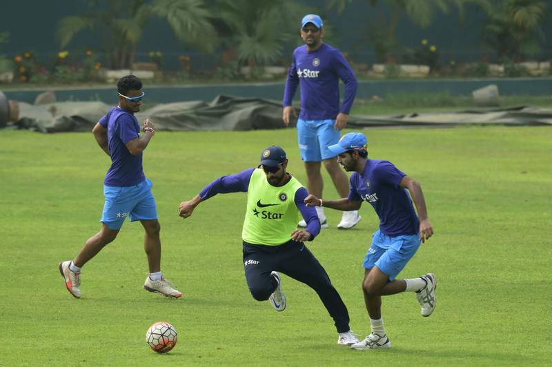 Indian cricketer Ravindra Jadeja, second from left, and Bhuvneshwar Kumar, right, play football with teammates during a training session at the Sher-e-Bangla National Cricket Stadium in Dhaka on March 5, 2016. AFP
