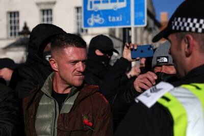 Far-right activist Tommy Robinson looks on as police block the access to the Cenotaph where the Armistice Day service was taking place in London. EPA
