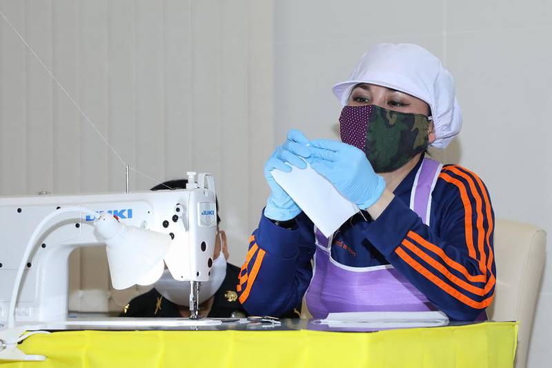 Thailand's Queen Suthida as she sews a face mask that will be donated to the public as a preventive measure against the spread of the coronavirus in Bangkok. AFP